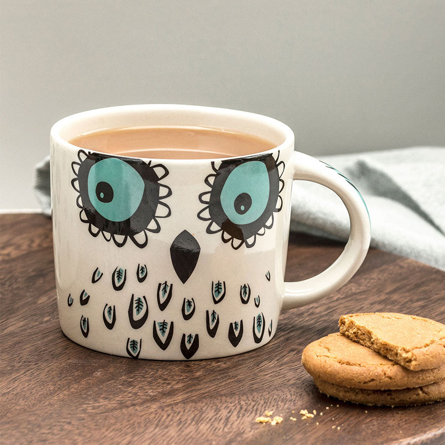 Cup of tea in owl mug by Hannah Turner
