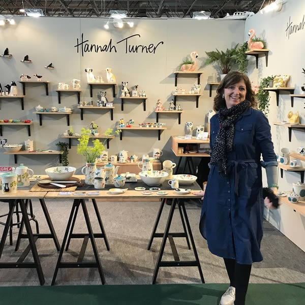 Hannah in front of trade show stall