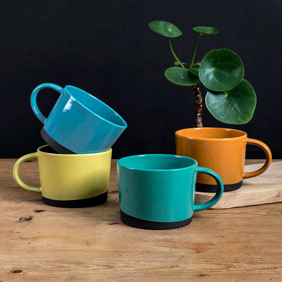 Dipped black clay mugs in blue, teal, yellow, orange
