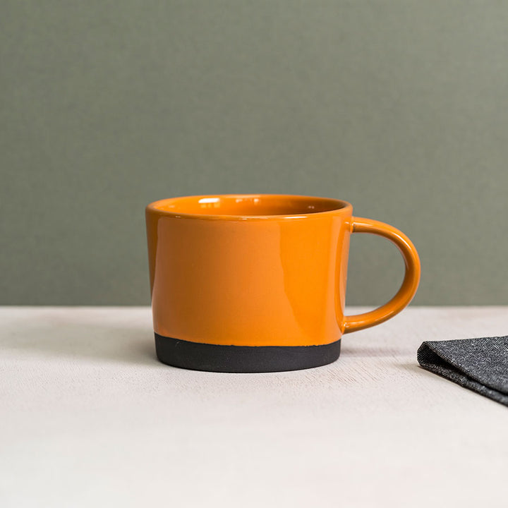 Black Clay Mug dipped in Orange Glaze by Hannah Turner