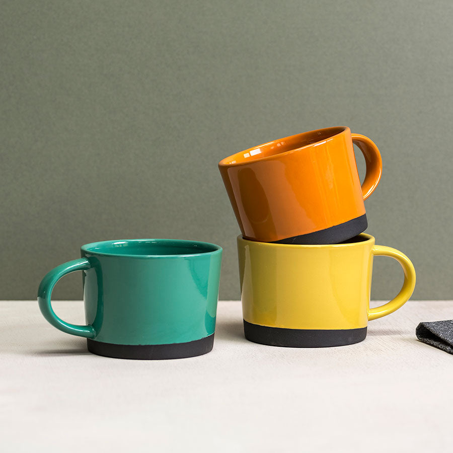 Black Clay Mugs dipped in Coloured Glazes by Hannah Turner