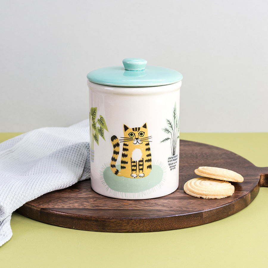 Ceramic Storage  jar with a cat design on a wooden board with cookies