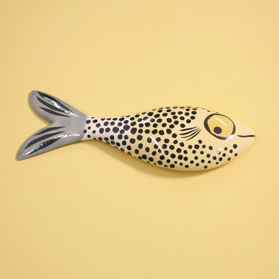 Fish-shaped  wall ornament  with black spots on a yellow background