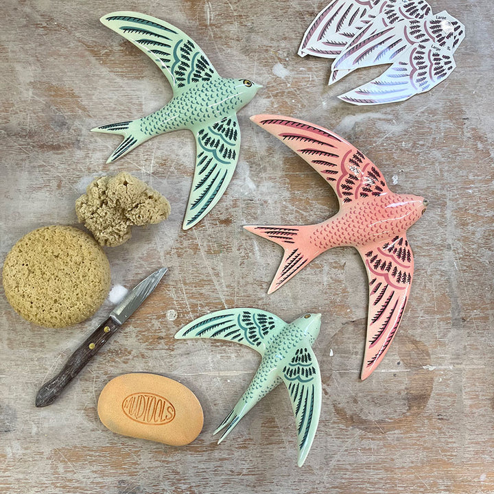 Three ceramic swift wall decorations by Hannah Turner