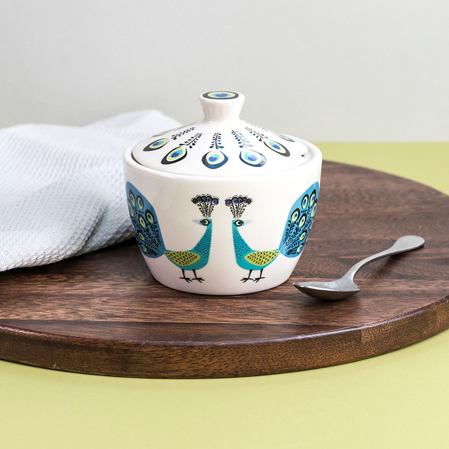 Peacock Sugar Bowl sits on a dark wooden chopping board, with a tea spoon 