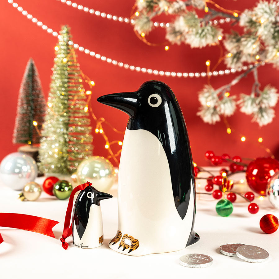 handmade ceramic penguin money box coin bank, and Penguin hanging christmas decoration by Hannah Turner