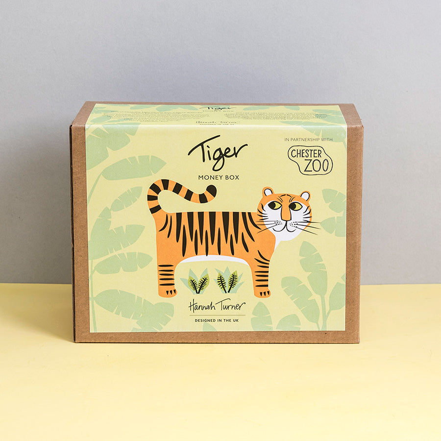Brown kraft gift box with tiger illustration and 'Chester Zoo' branding by Hannah Turner on a neutral background. Packaging for Hannah Turner's Tiger Money Box.
