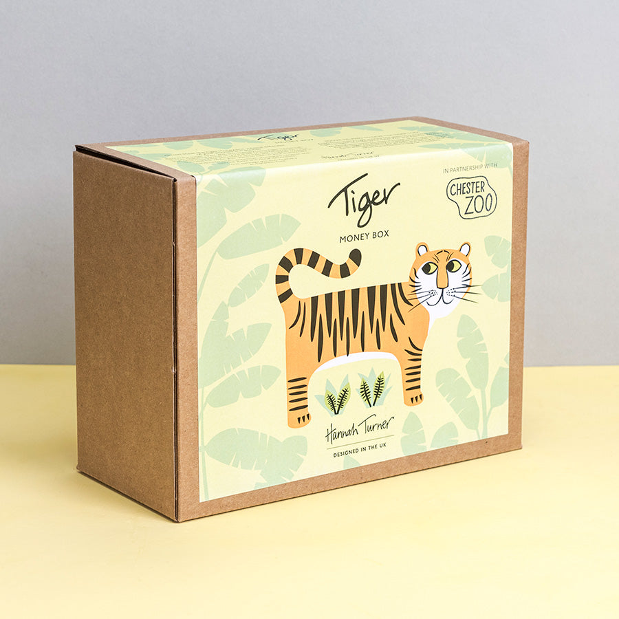 Brown kraft gift box with tiger illustration and 'Chester Zoo' branding by Hannah Turner on a neutral background. Packaging for Hannah Turner's Tiger Money Box.