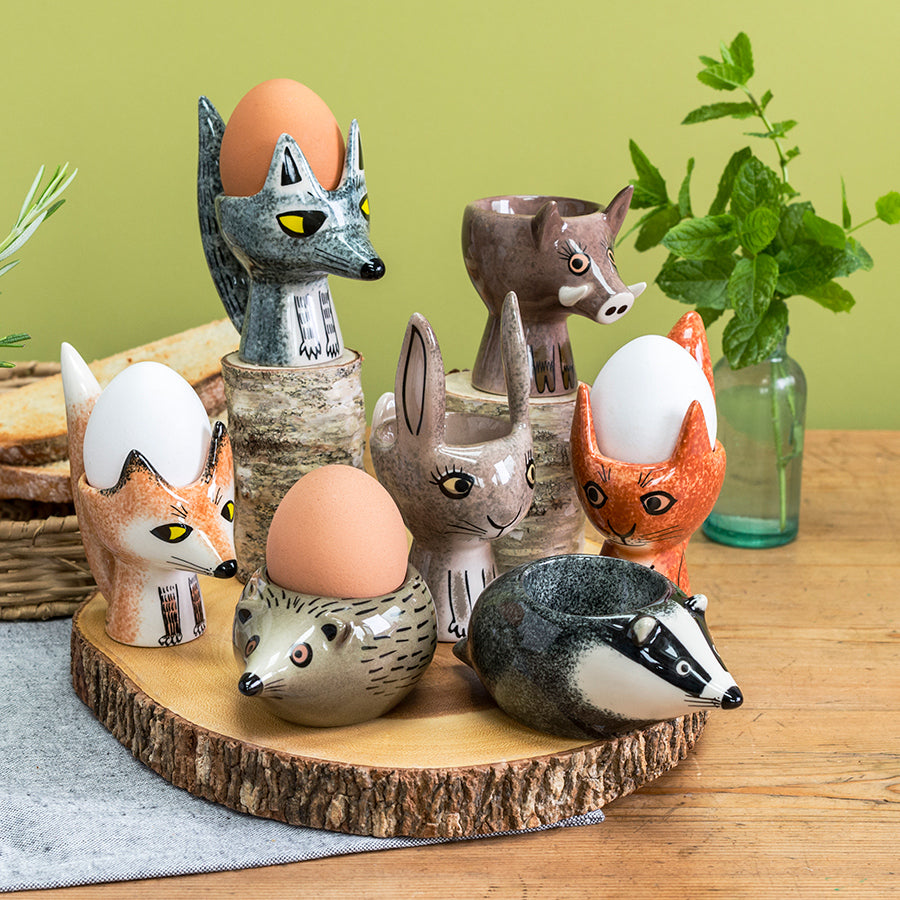 A colourful collection of ceramic wildlife egg cups in a breakfast setting 