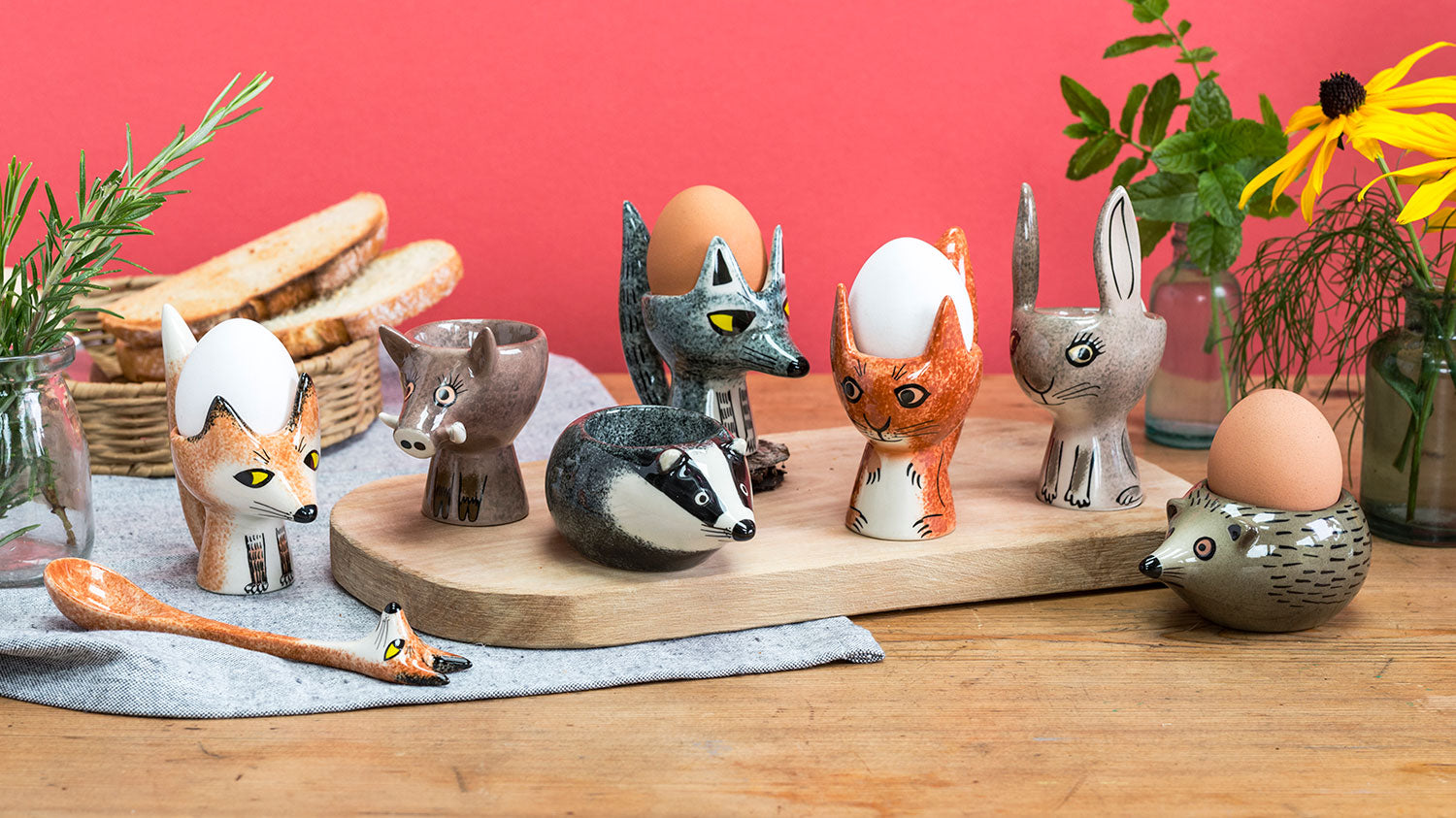 A colourful collection of ceramic wildlife egg cups in a breakfast setting 