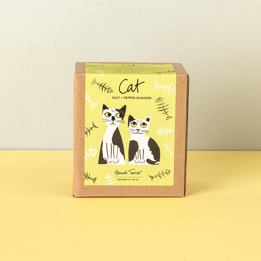 A square kraft paper box for black and white cat salt and pepper shakers, featuring a yellow-green label with illustrations of two cats and the text 'Cat Salt & Pepper Shakers'.