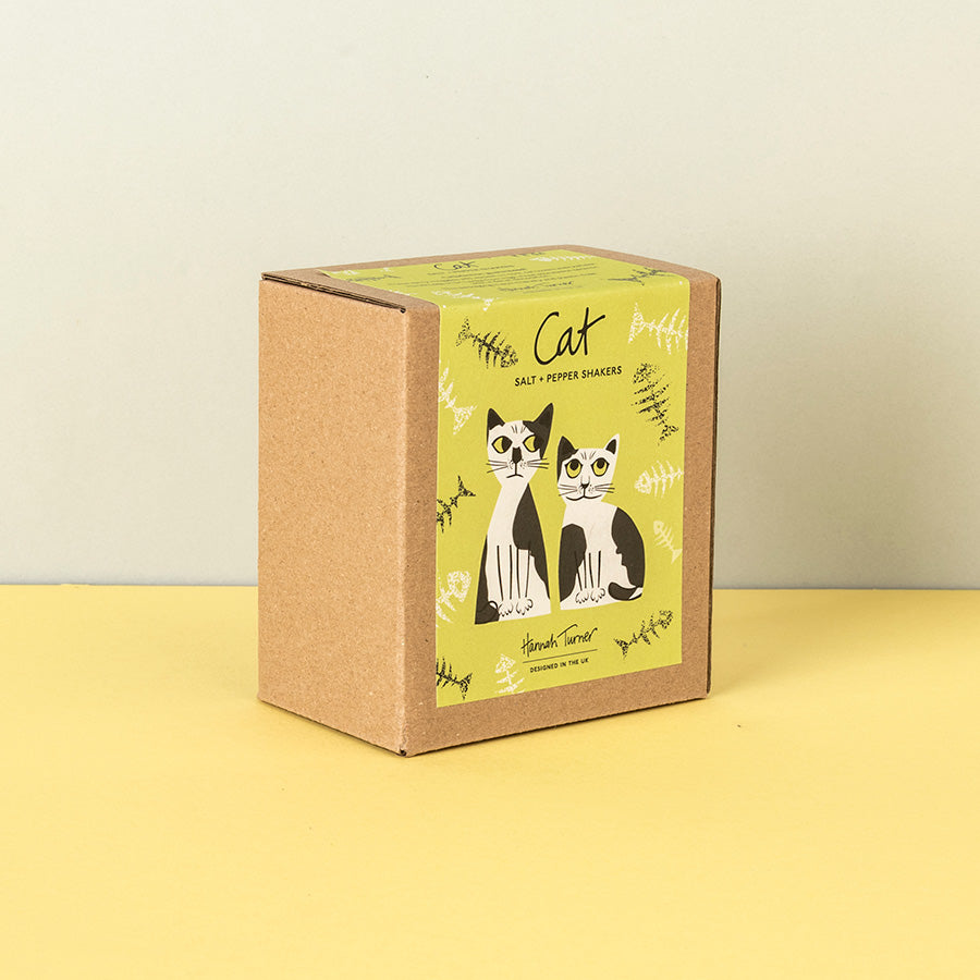 A square kraft paper box for black and white cat salt and pepper shakers, featuring a yellow-green label with illustrations of two cats and the text 'Cat Salt & Pepper Shakers'.